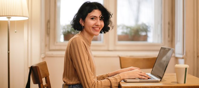woman-in-brown-long-sleeve-shirt-sitting-on-brown-wooden-3915966.jpg