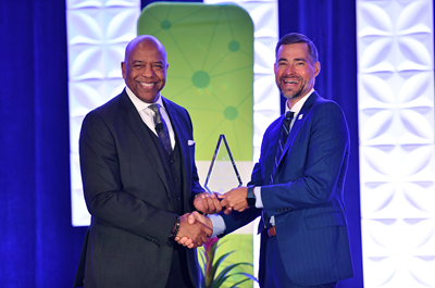 Outgoing NMSI CEO, Bernard A. Harris, Jr. receiving the ECS James Bryant Conant award from incoming, NMSI CEO, Jeremy Anderson, July 2022.